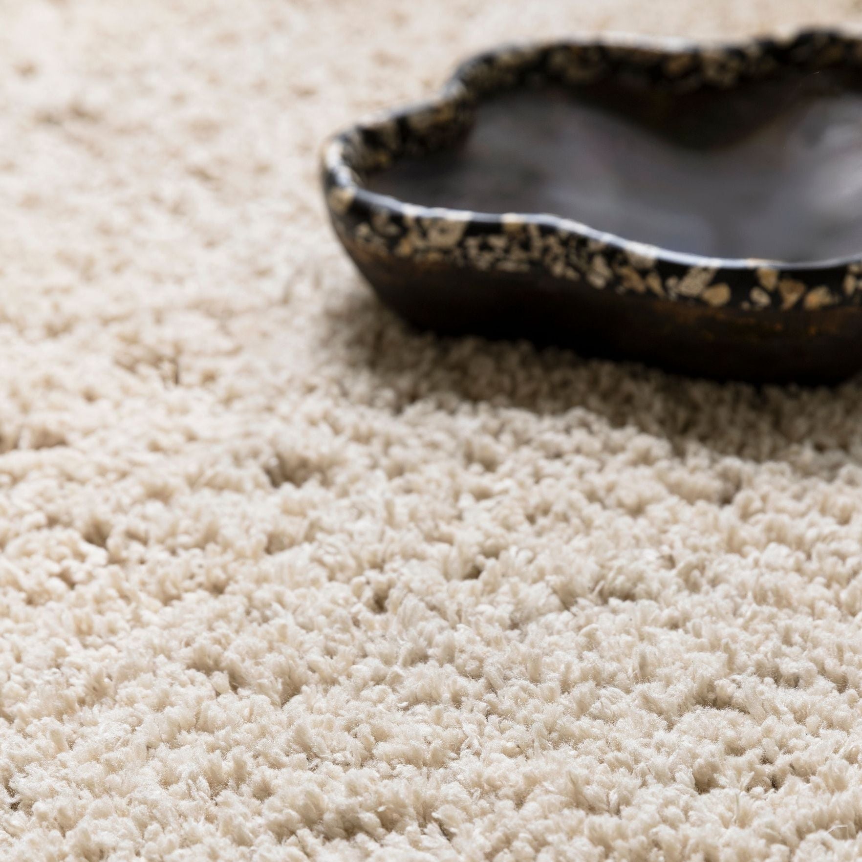 Celeste vloerkleed van MUST Living in beige, close-up van de lange zachte pool met donkere schaal