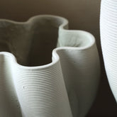 Hastin vaas van PTMD gestyled in een interieur, beige cementen vaas met takken