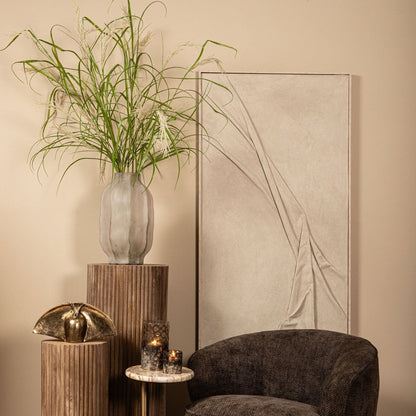 Natae Beige Round Glass Ribbed Vase High van PTMD in een sfeervolle hoek van de woonkamer