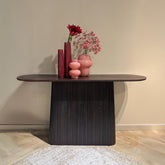 Salvator sidetable in Walnut tegen een lichte wand met bloemen erop